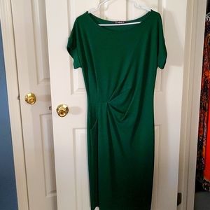 Never worn, rich green, knee length dress. Tags removed when dry cleaned.